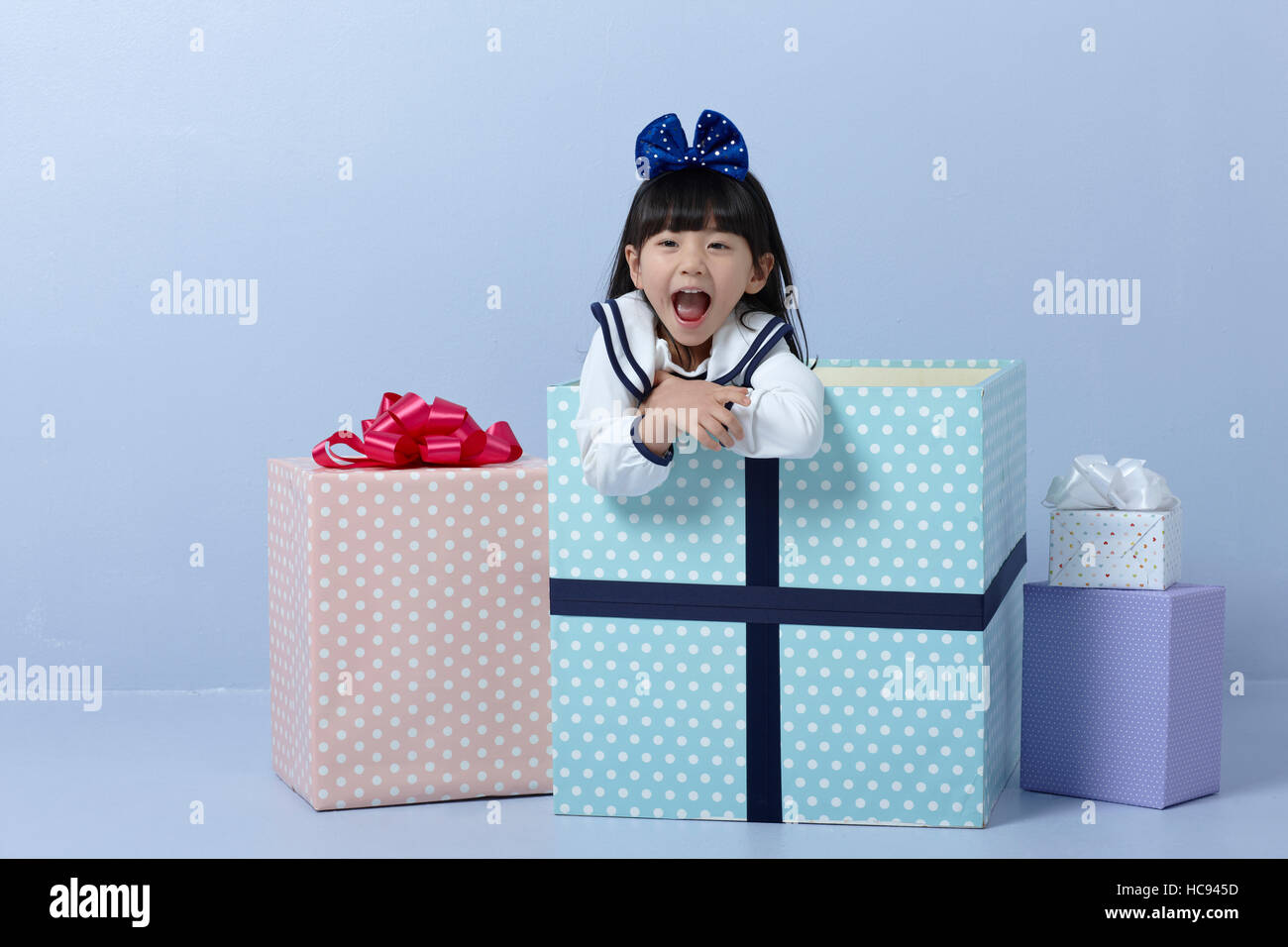 Portrait of smiling girl with present boxes Stock Photo - Alamy