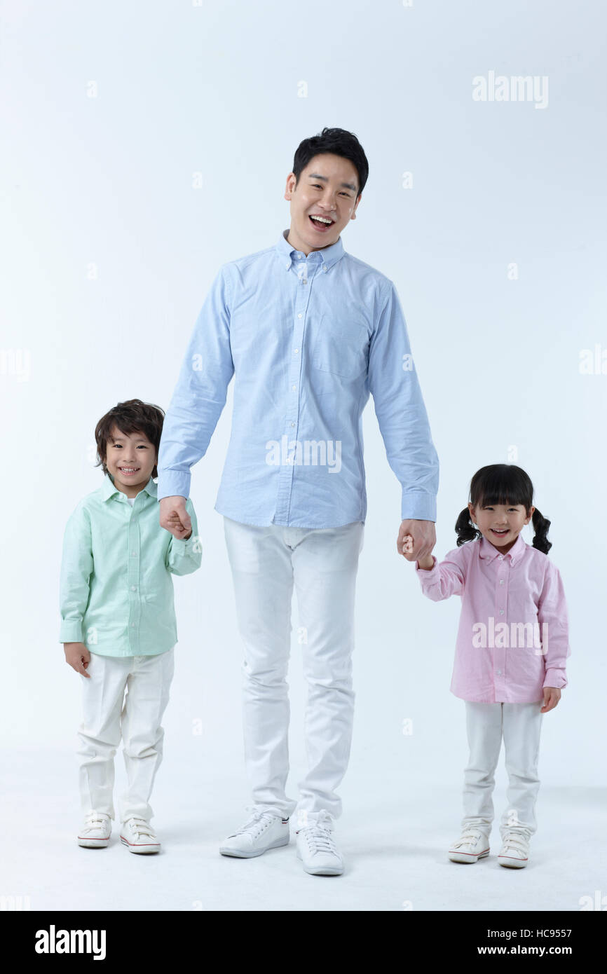 Loving father standing with his son and daughter hand in hand Stock ...