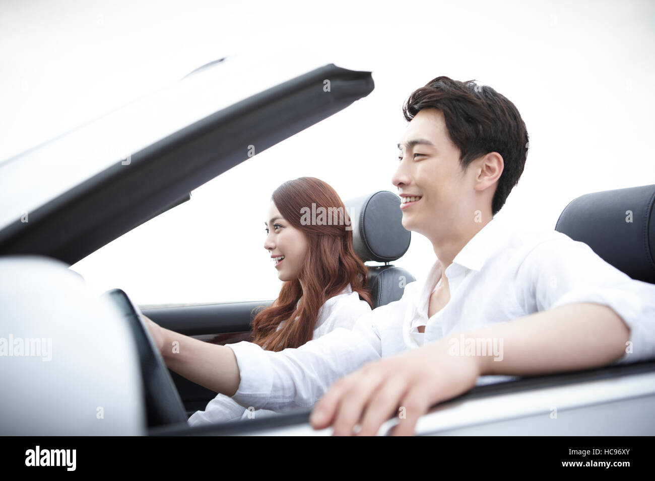 Young smiling couple in a car Stock Photo - Alamy