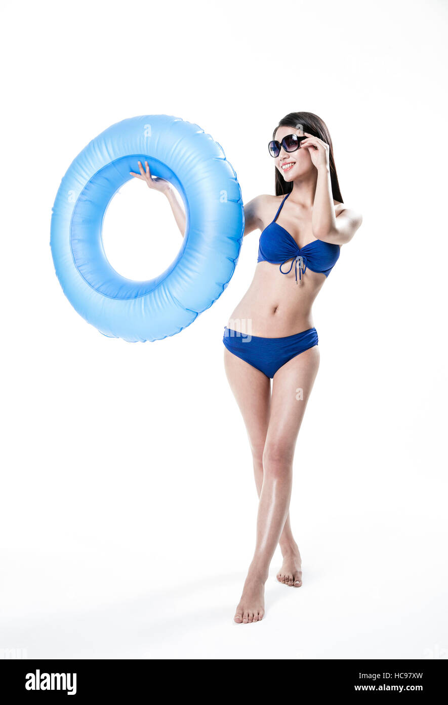 Young smiling slim woman in bikini posing with a tube Stock Photo