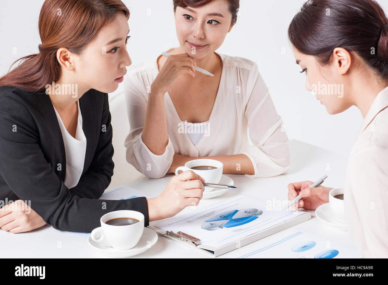 Three young businesswomen having a meeting Stock Photo - Alamy