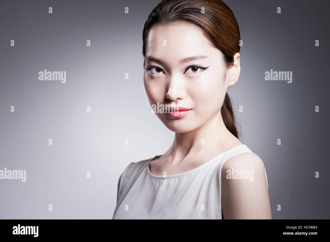 Portrait of young Korean woman with ponytail and black eyeliner Stock
