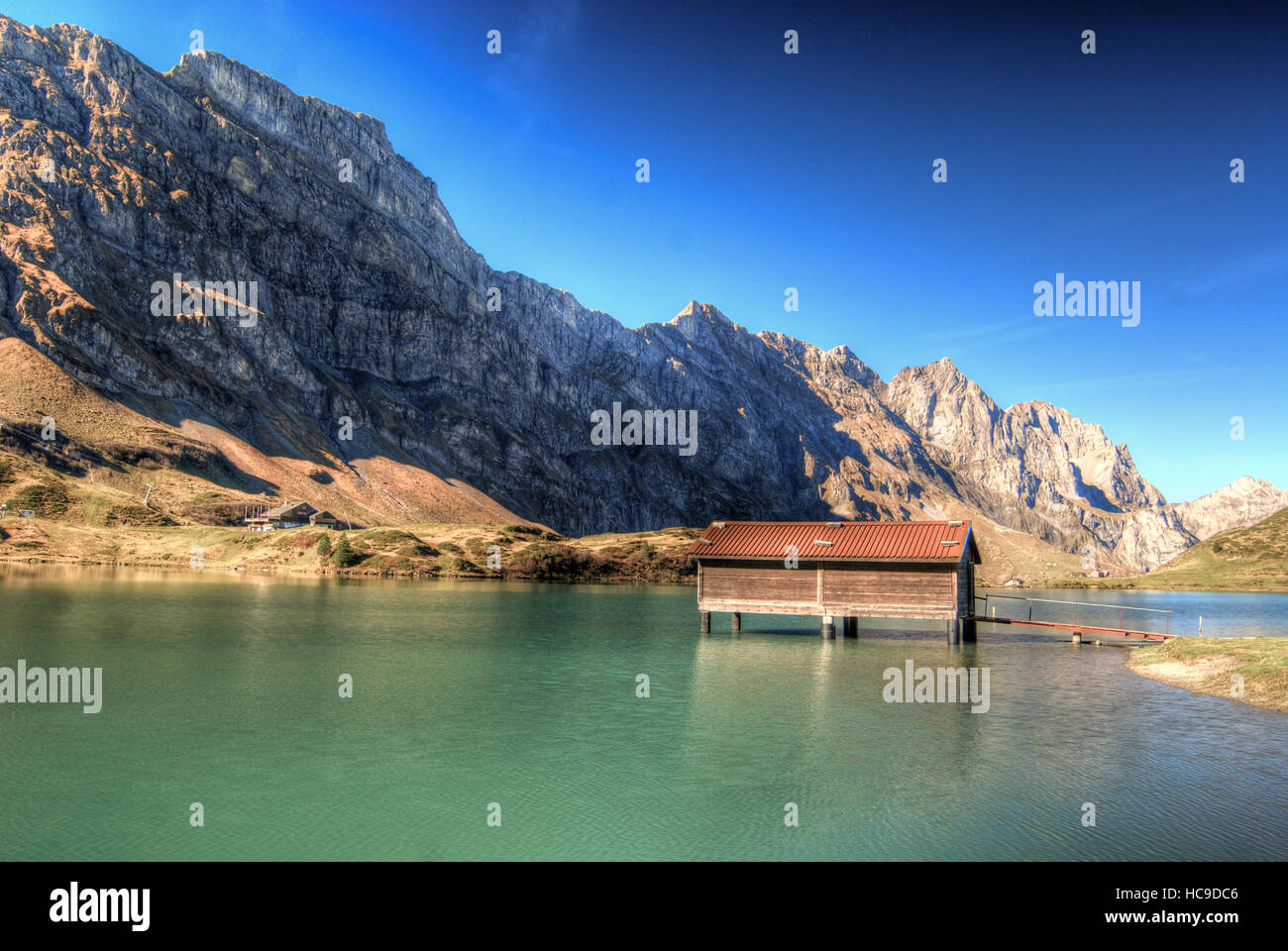 Mountain Cabin On A Lake In The Alps Switzerland Stock Photo