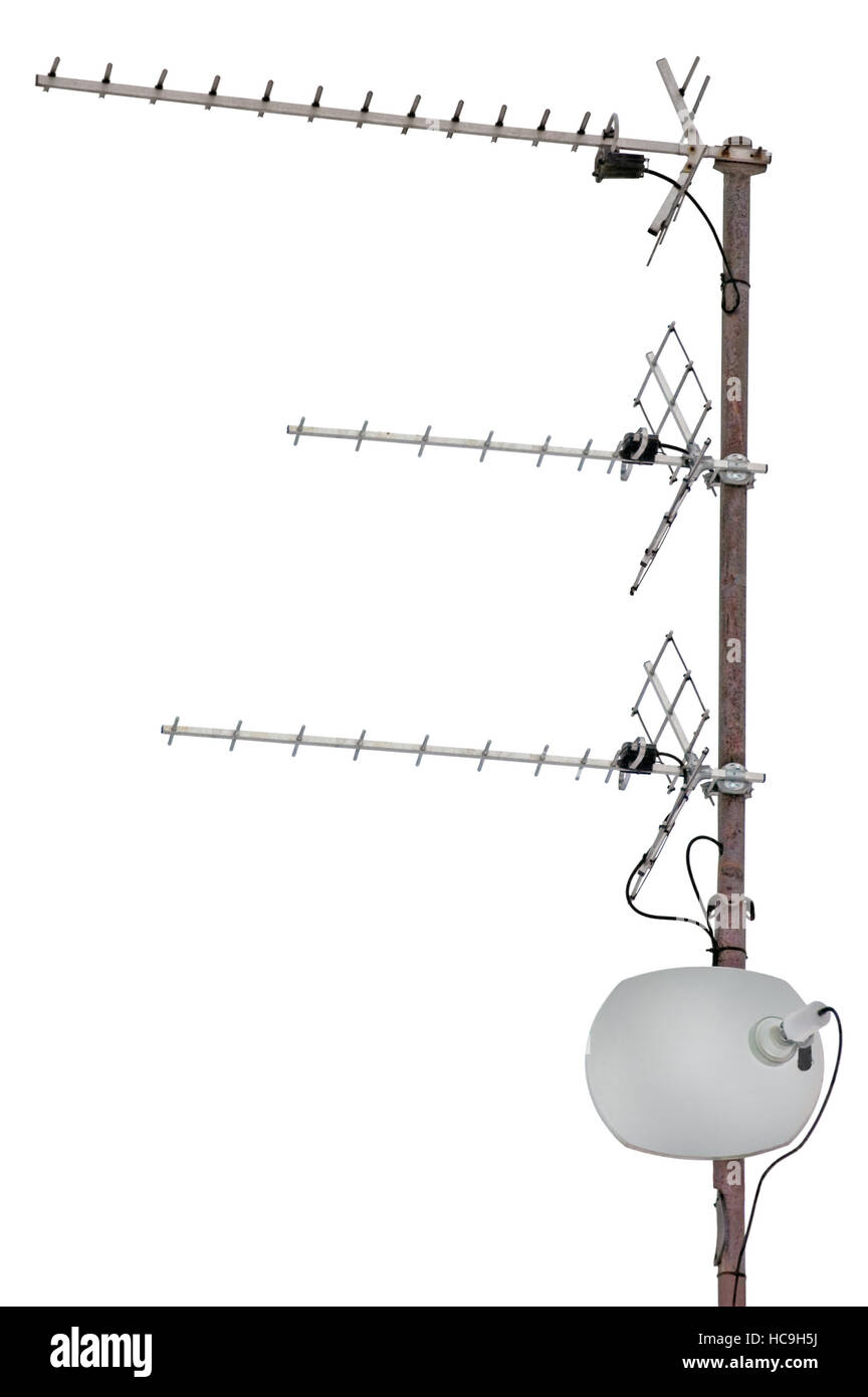 TV and communication aerials on roof of residential house, isolated antennas and satellite dish Stock Photo
