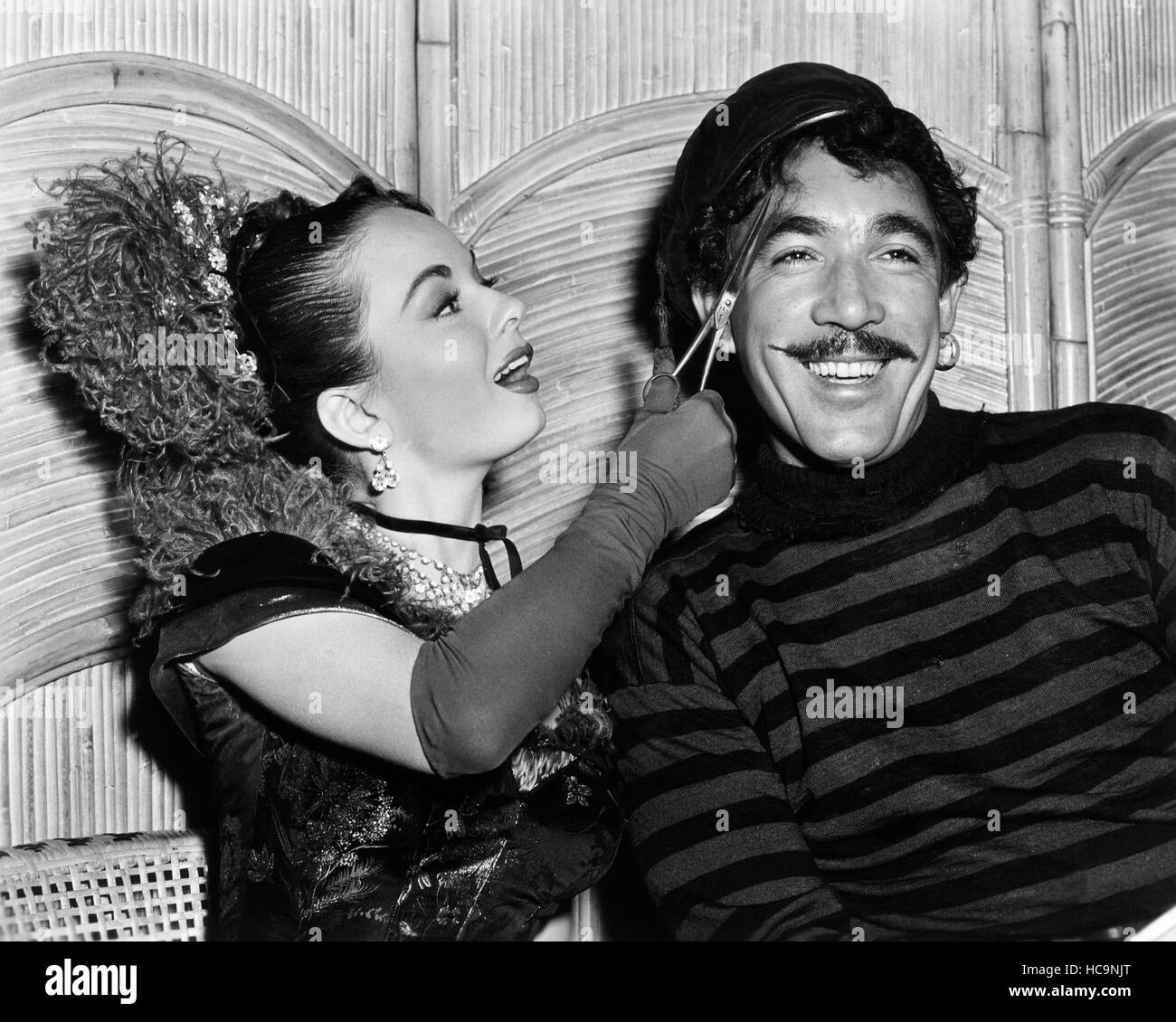 THE WORLD IN HIS ARMS, Ann Blyth cuts Anthony Quinn's hair between ...