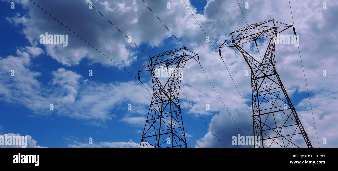 Electrical power line against cloud and blue sky Stock Photo - Alamy