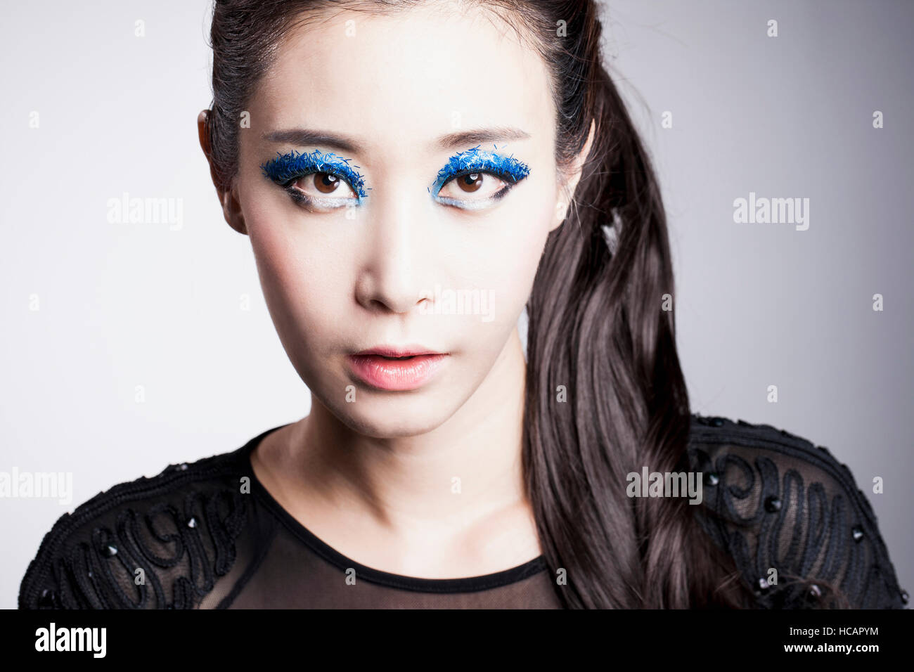 Portrait of young Korean woman in blue eye shadow Stock Photo - Alamy