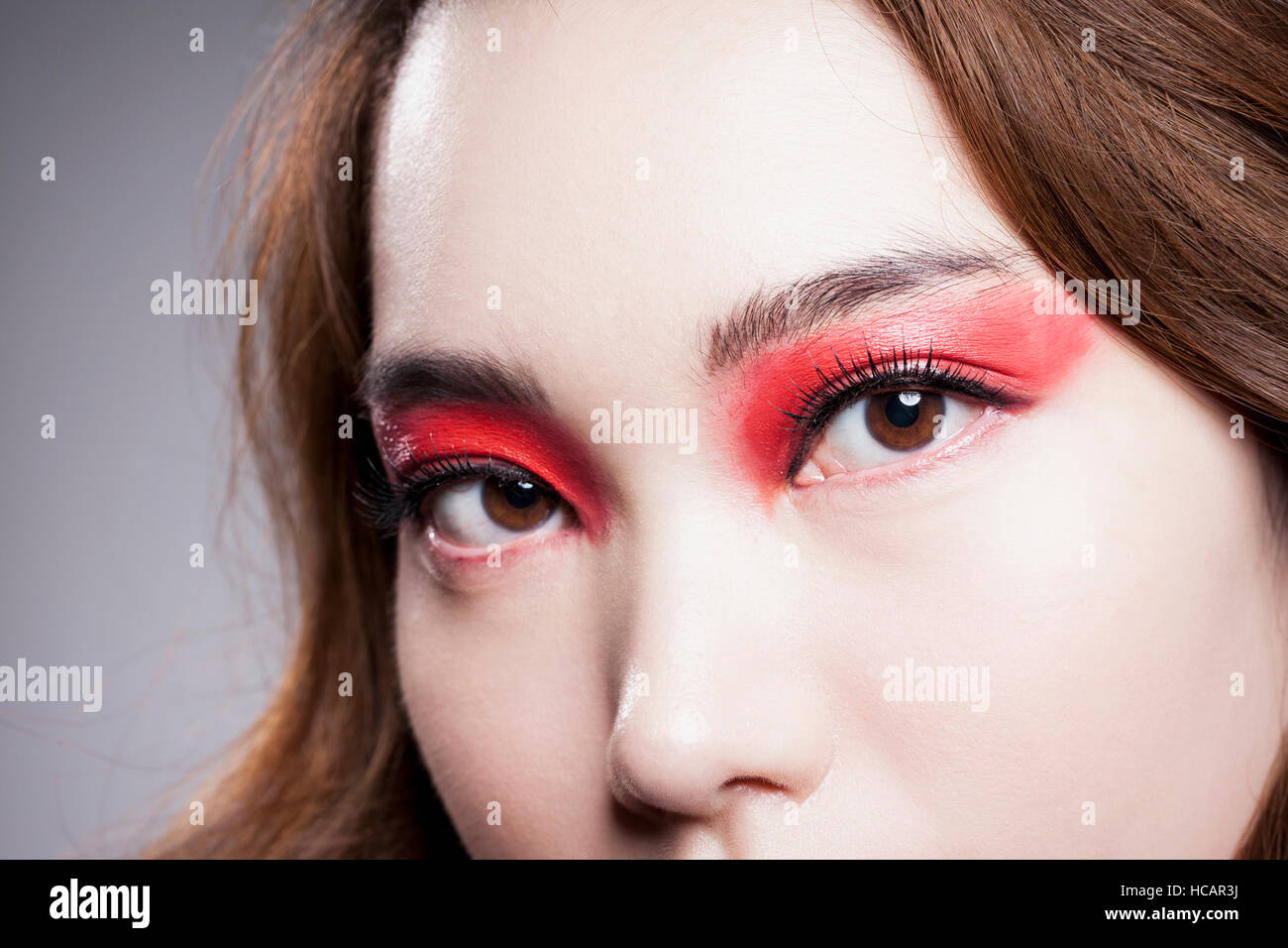 Portrait of young Korean woman in red eye shadow Stock Photo
