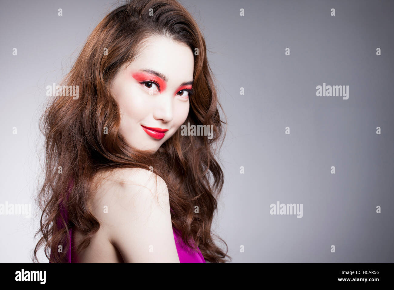 Portrait of young Korean woman in red eye shadow and red lips Stock