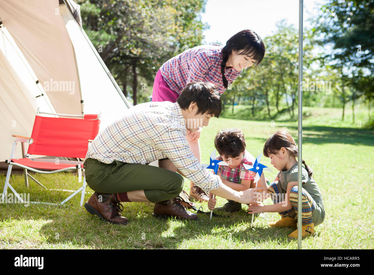 Harmonious family setting up a tent stock photo alamy