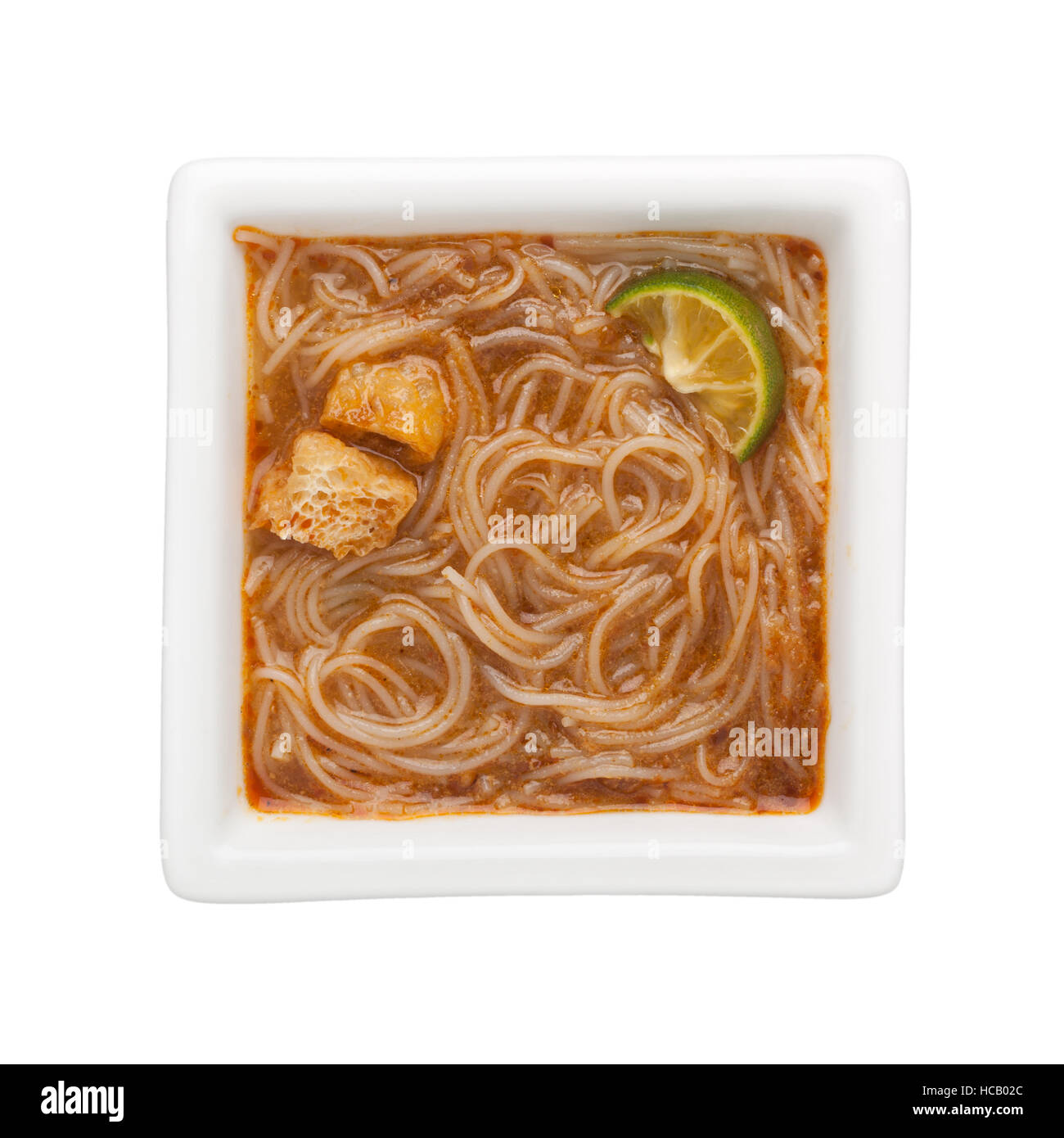 Peranakan food - Mee siam in a square bowl isolated on white background Stock Photo