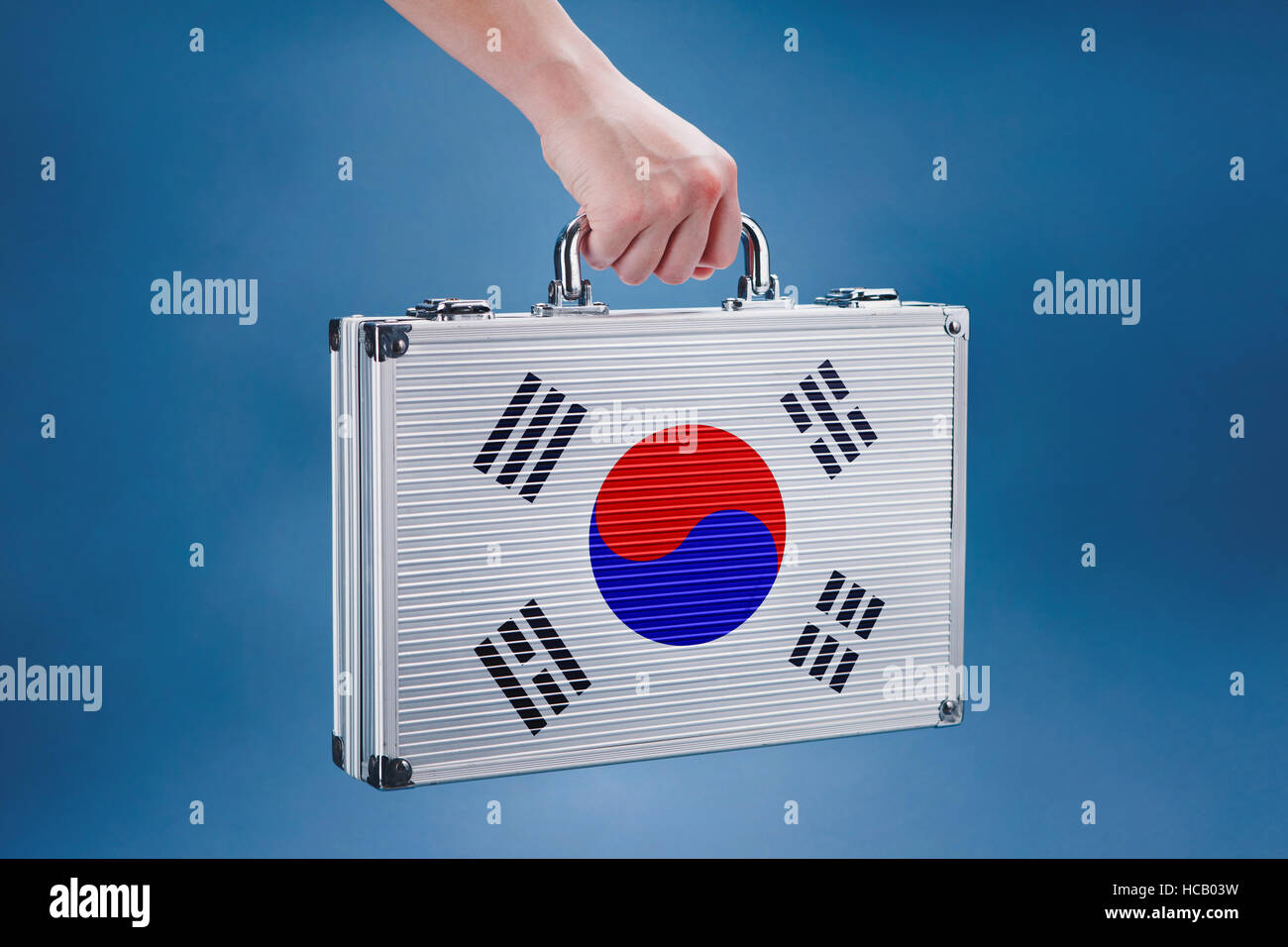 Hand holding a briefcase with Korean flag Stock Photo