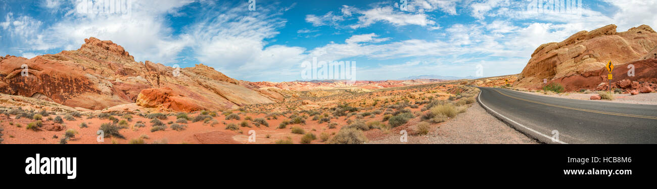 Road between red sandstone formations, Valley of Fire, Mojave Desert, Nevada, USA Stock Photo