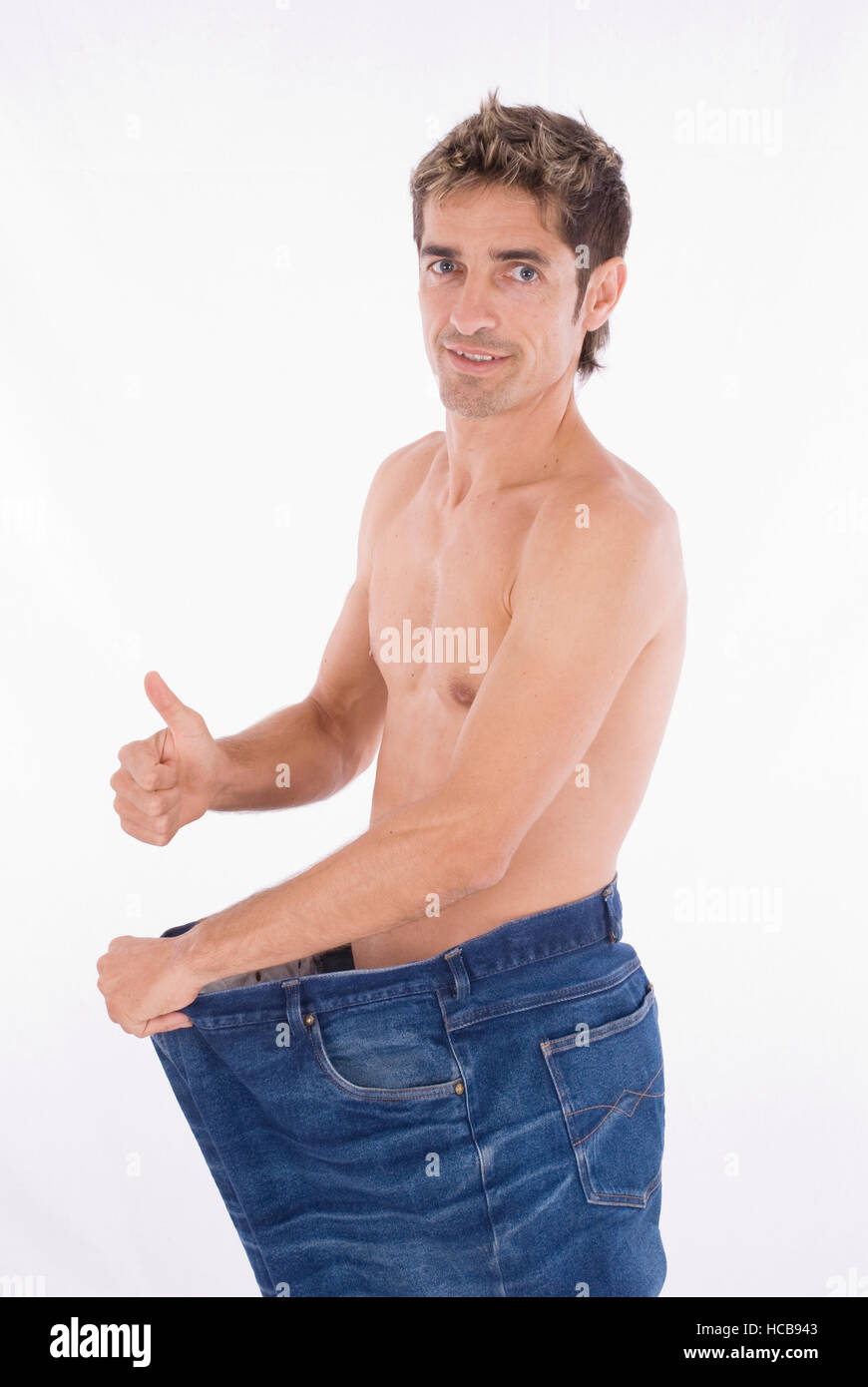Man in trousers that are too big after a successful diet Stock Photo