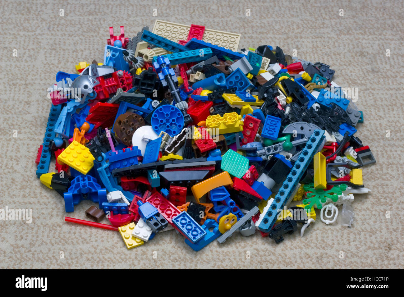 VILNIUS,  LITHUANIA - NOVEMBER 12, 2016: On a carpet in the nursery a heap of Lego toy blosks and elements. Lego Group began manufacturing the interlo Stock Photo
