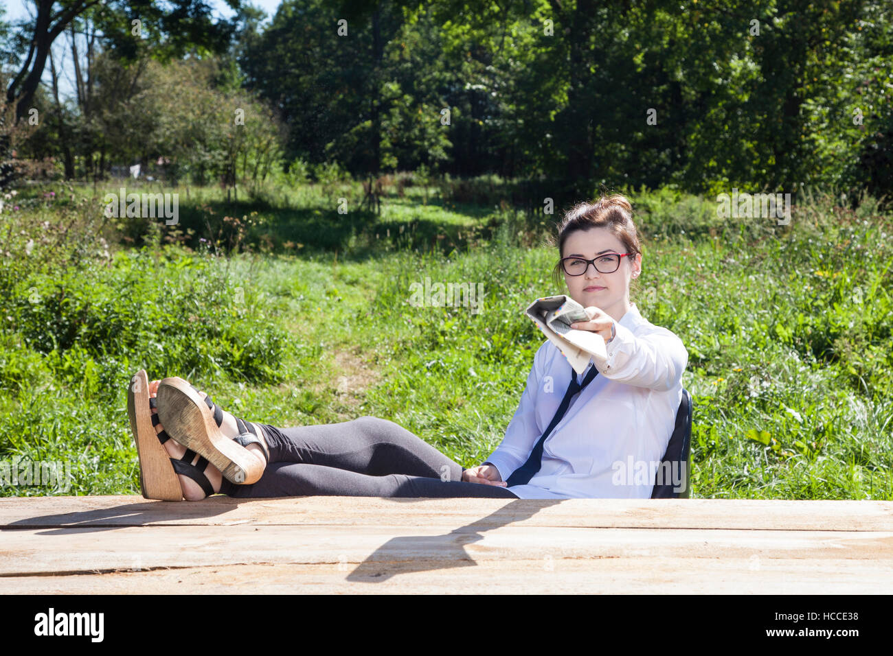 business woman gives newspaper Stock Photo - Alamy