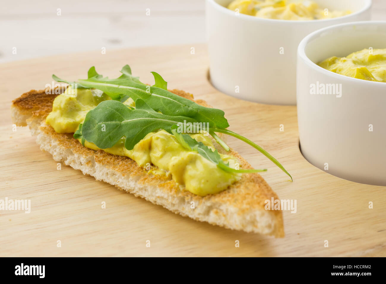 Toast with dutch curried chicken salad and rocket salad Stock Photo