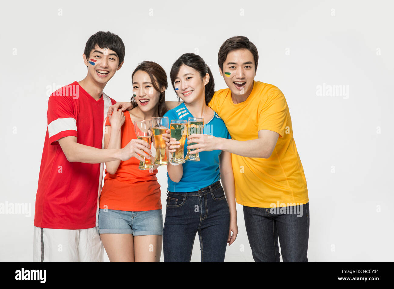 Young smiling people with beer glasses cheering Stock Photo