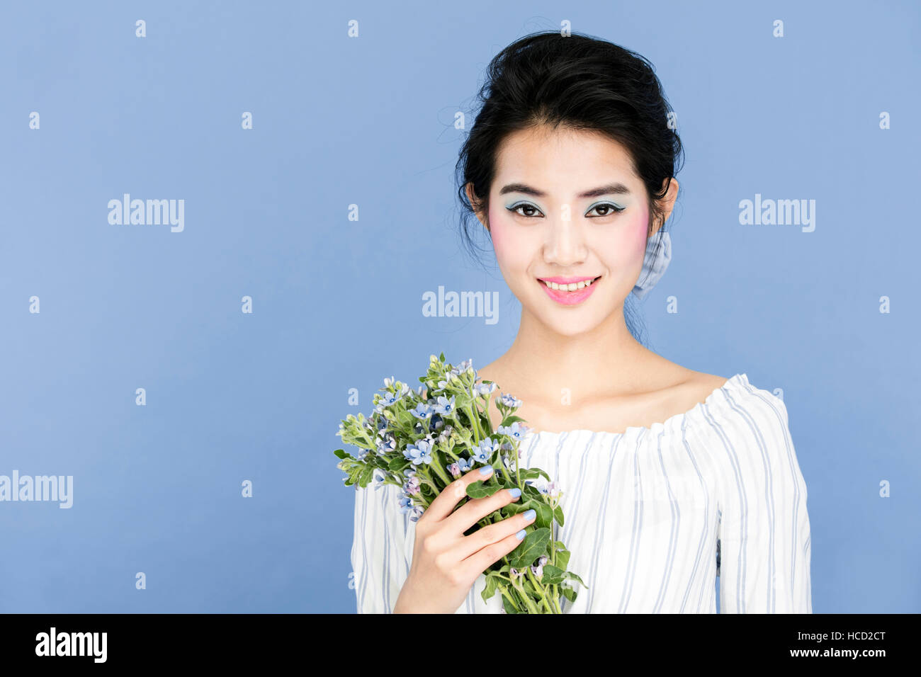 Portrait of young smiling woman with wild flowers Stock Photo - Alamy