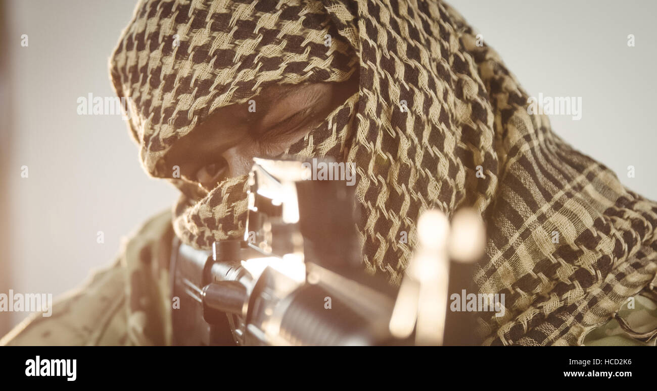 Terrorist aiming with machine gun Stock Photo