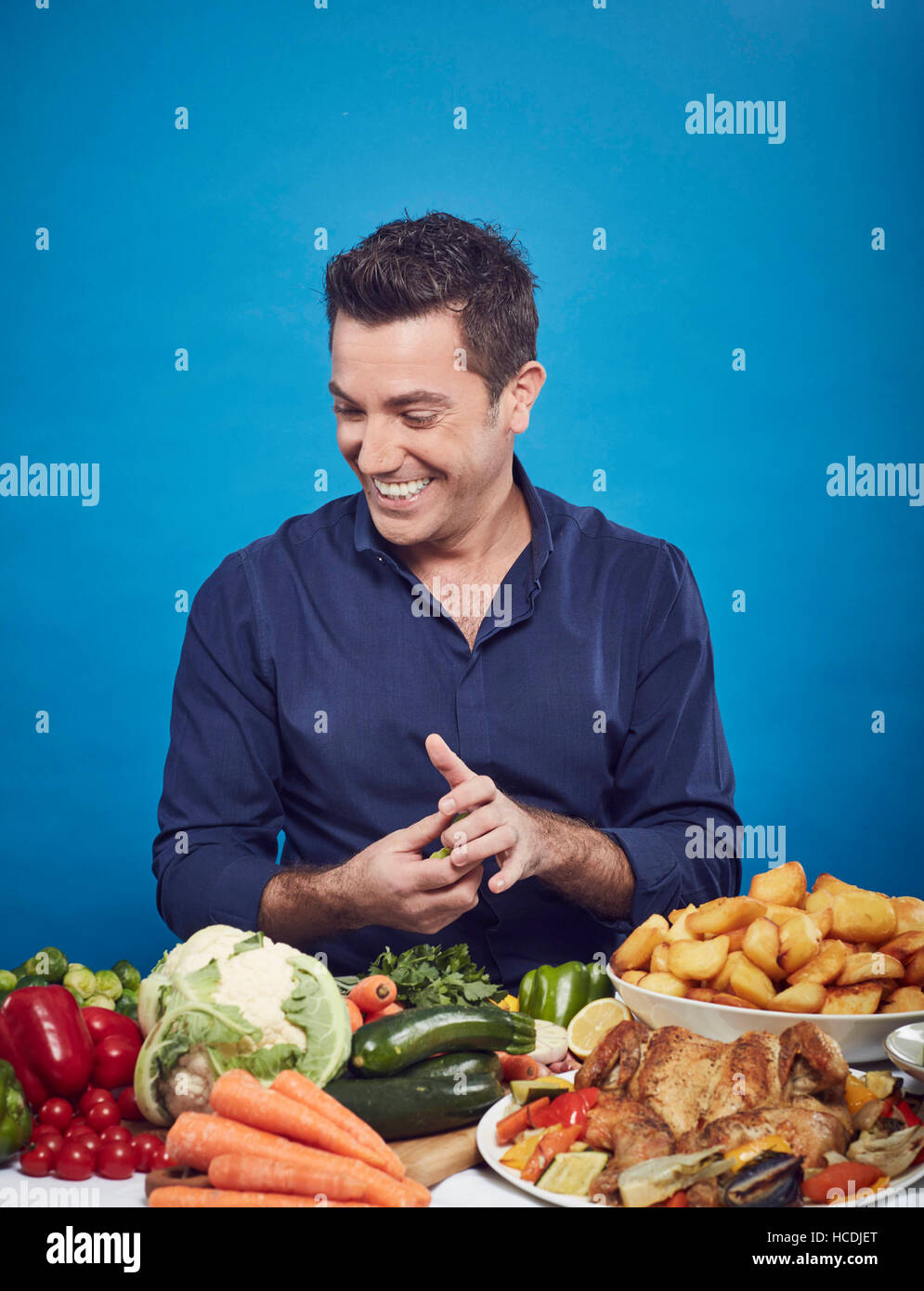 EDITORIAL USE ONLY Celebrity chef Gino D'Acampo makes a roast dinner