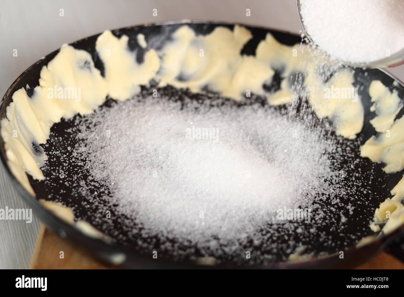 Sprinkle sugar over frying pan. Making Apple Tarte Tatin with Cinnamon