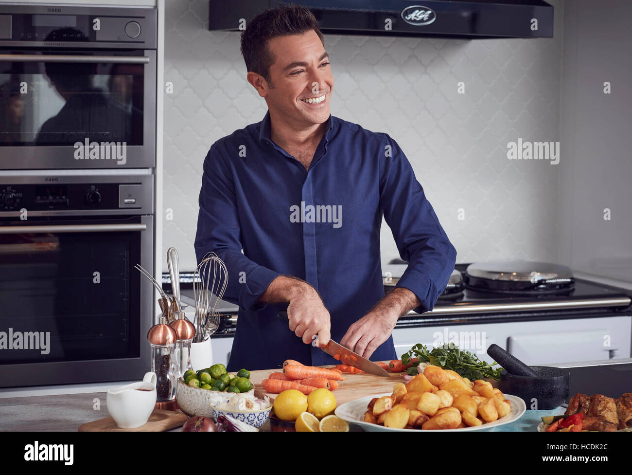 EDITORIAL USE ONLY Celebrity chef Gino D'Acampo makes a roast dinner