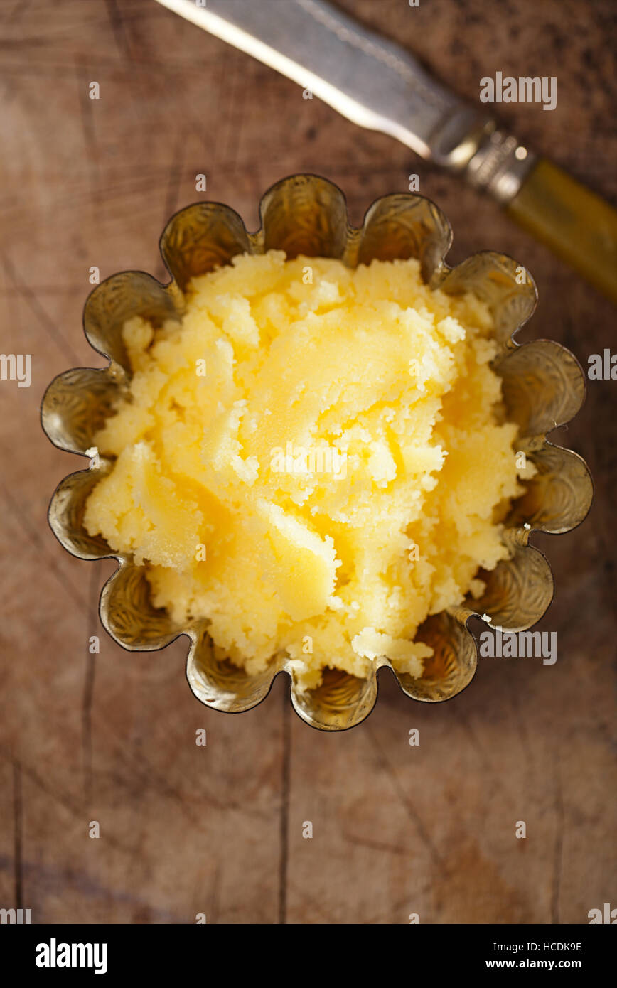 https://c8.alamy.com/comp/HCDK9E/ghee-or-melted-butter-in-mold-on-wooden-table-HCDK9E.jpg