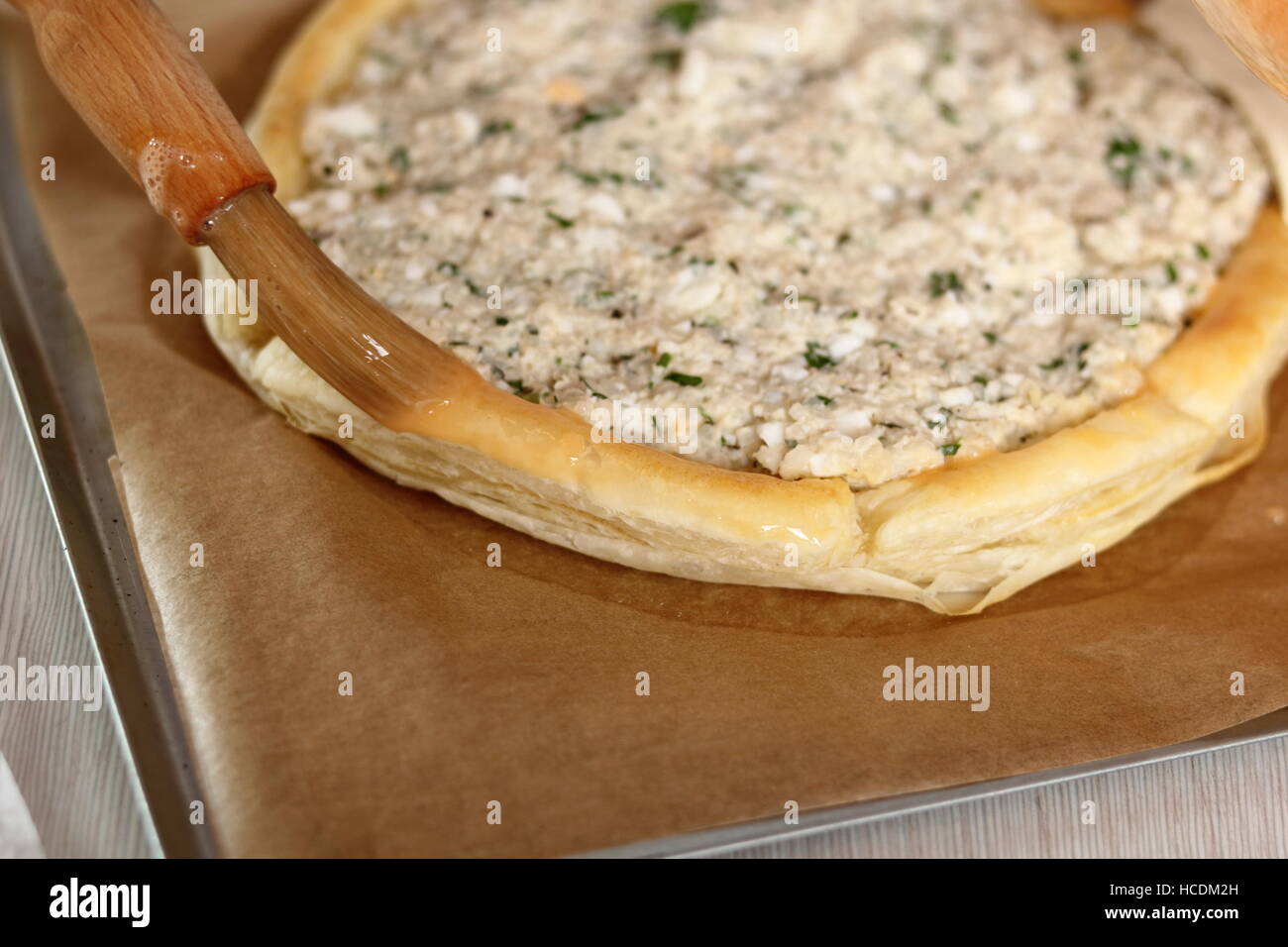 Brush with Egg Glaze Edge of Pastry Parcel. Making Salmon in Puff