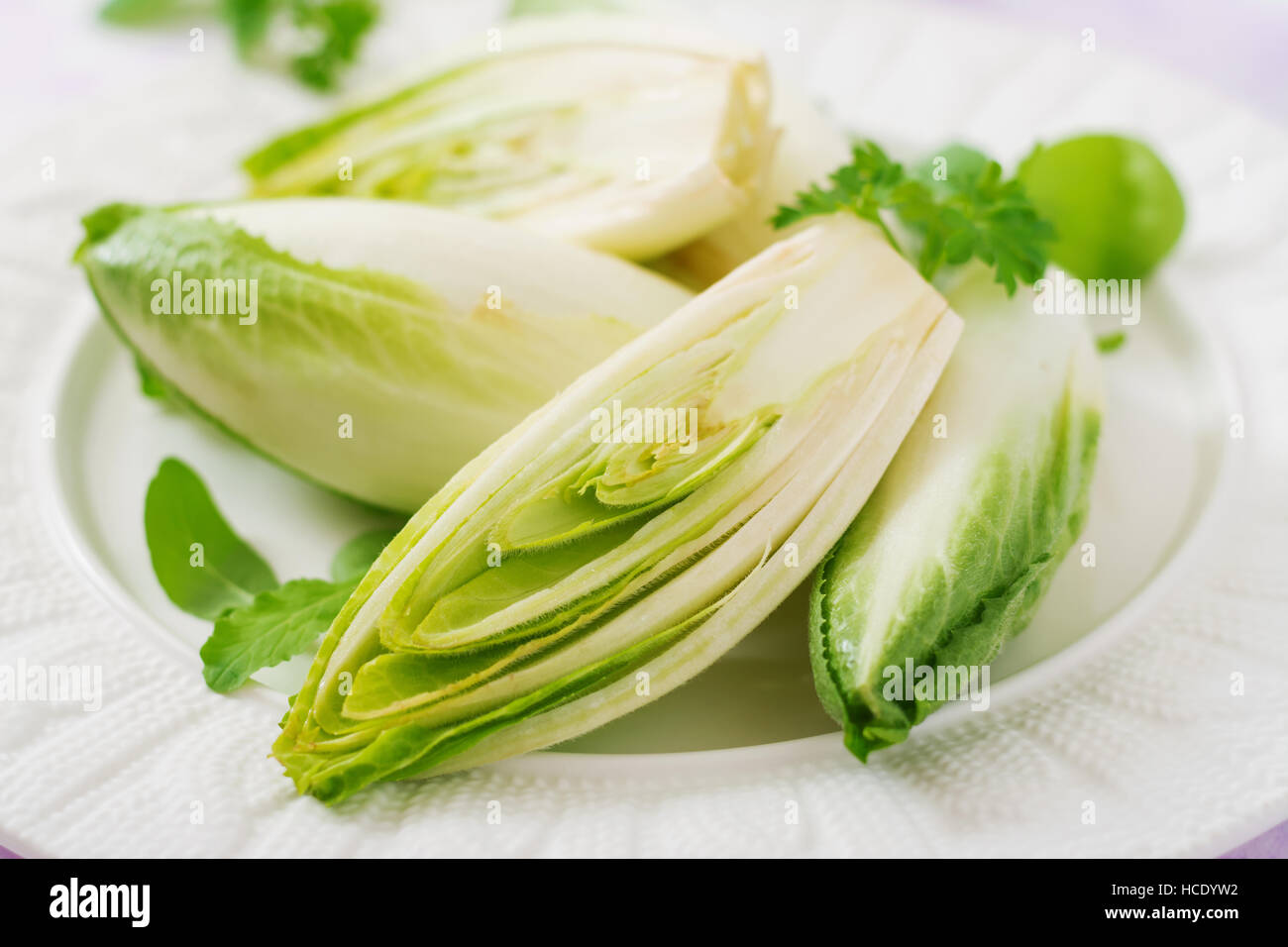 Fresh and healthy Chicory (witloof) Salad on a plate. Dietary menu. Healthy food. Stock Photo
