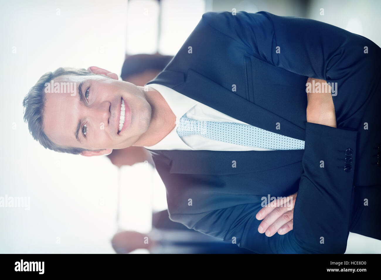 Portrait of young businessman smiling at camera Stock Photo - Alamy