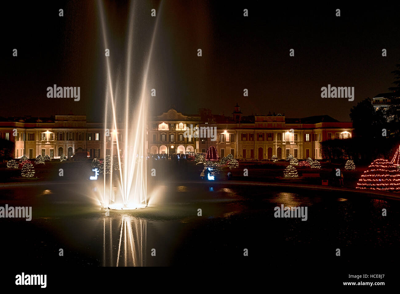 Fountain in the foreground and Christmas lights in the public gardens of Varese Stock Photo