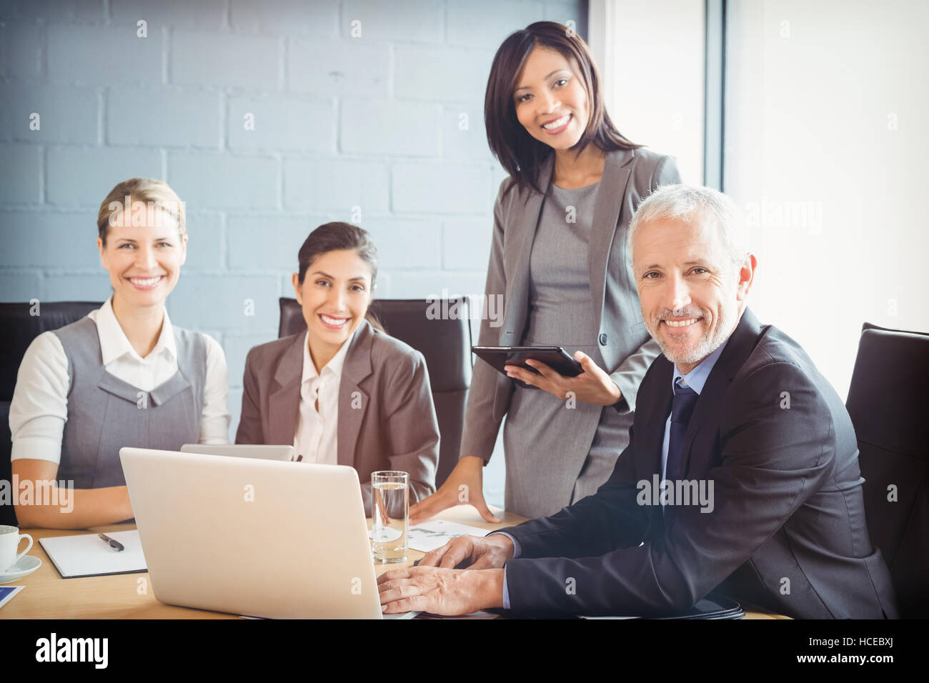 Portrait of business people at meeting in conference room Stock Photo ...