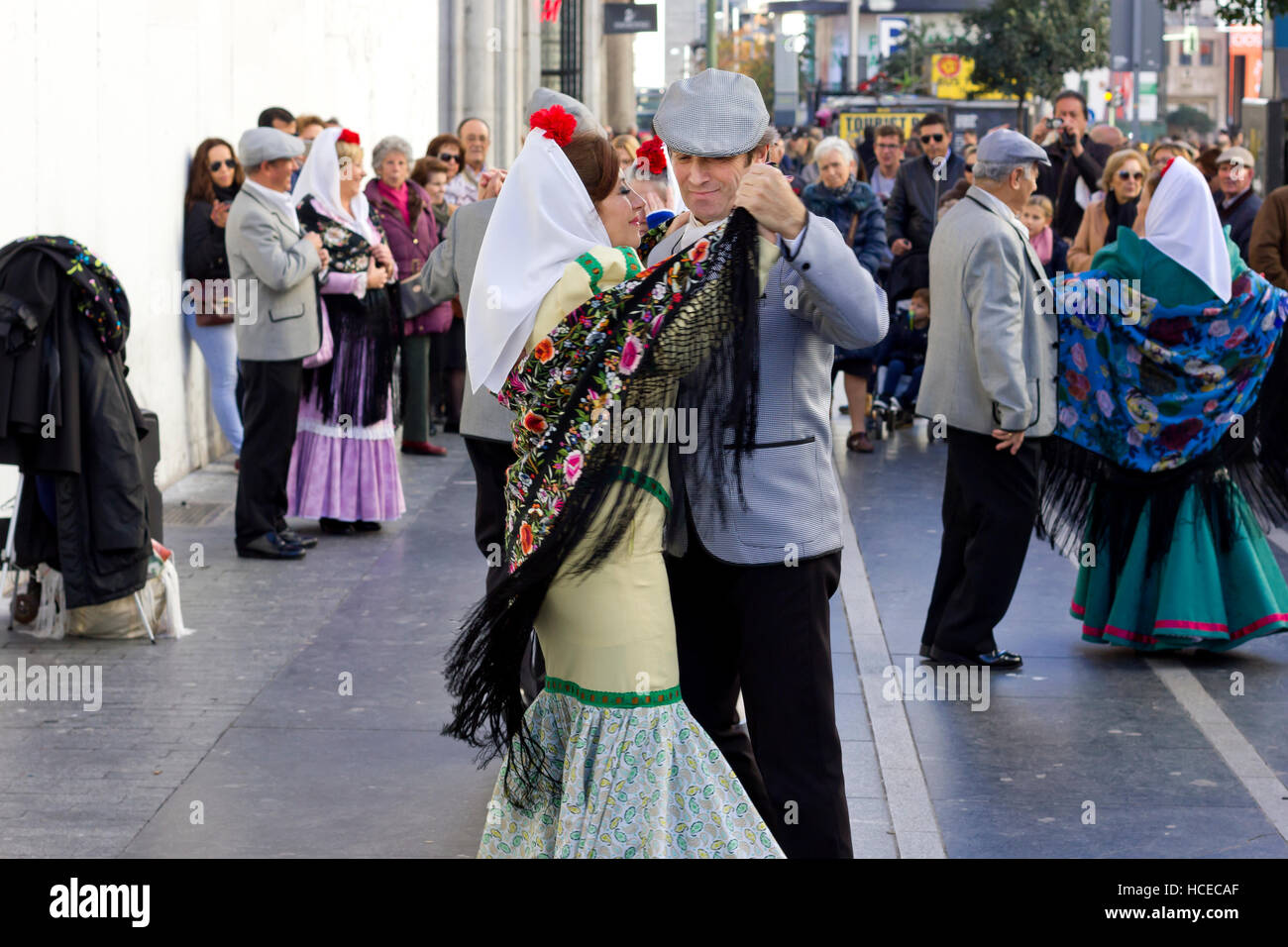Old couples dancing traditional dance chotis outdoors in Gran Via (Madrid, Spain). Stock Photo