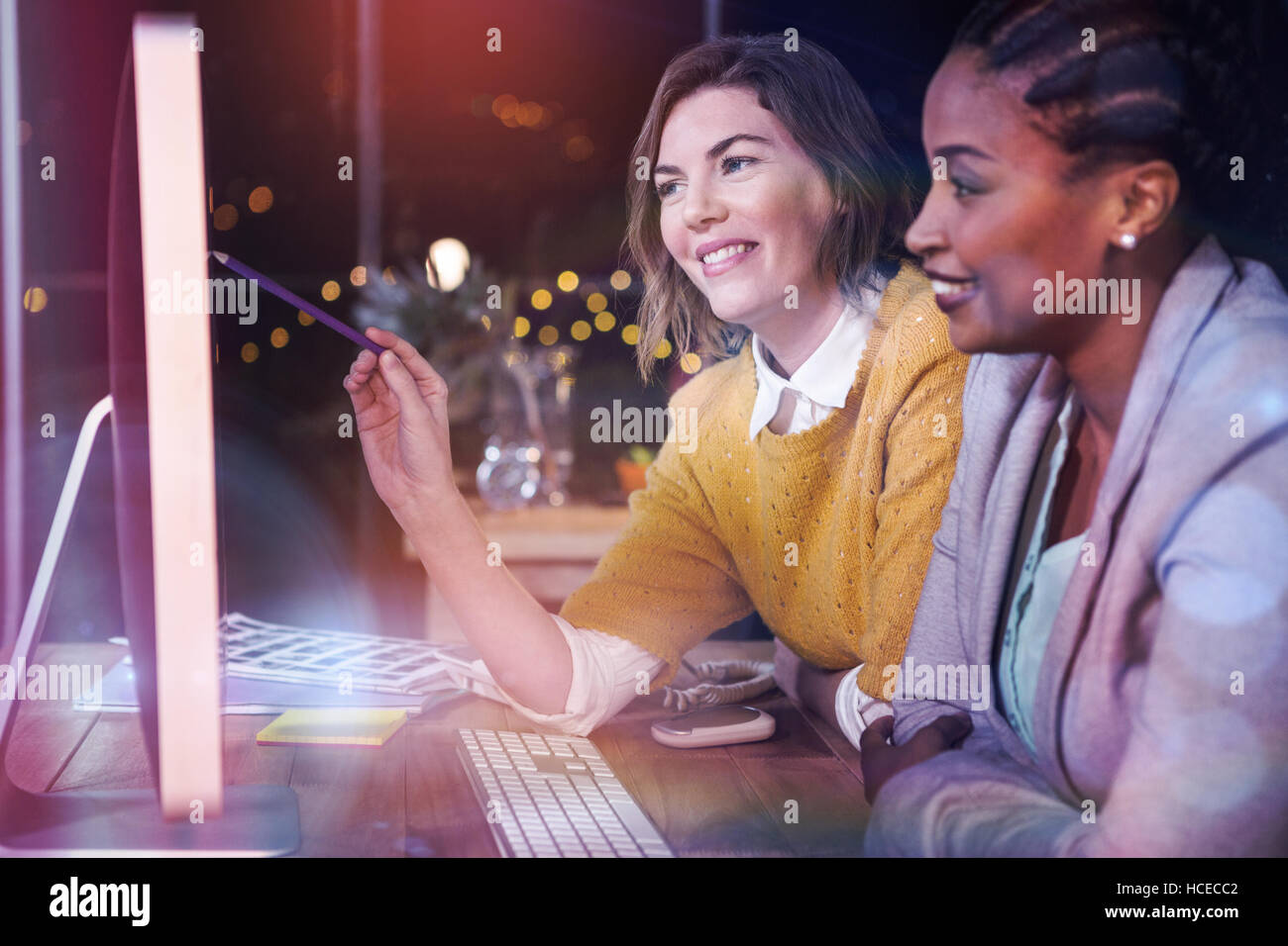 Businesswomen working on computer at desk Stock Photo - Alamy