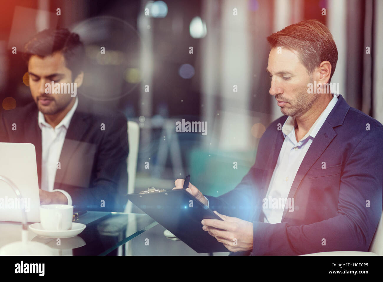 Businessman writing on clipboard Stock Photo - Alamy
