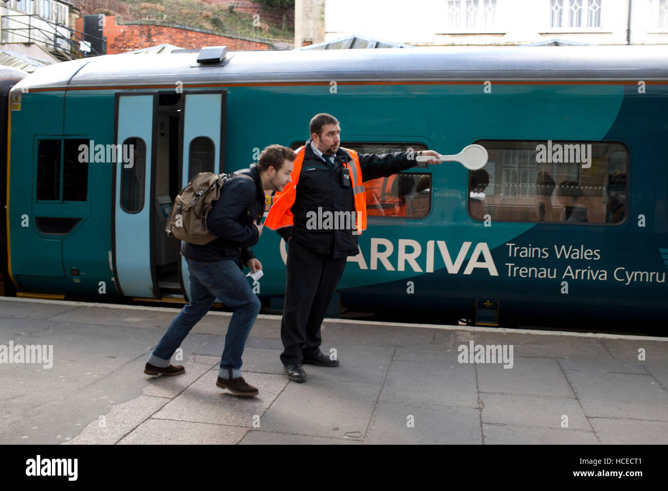 Guard about to wave off Arriva Wales train, Shrewsbury station Stock Photo
