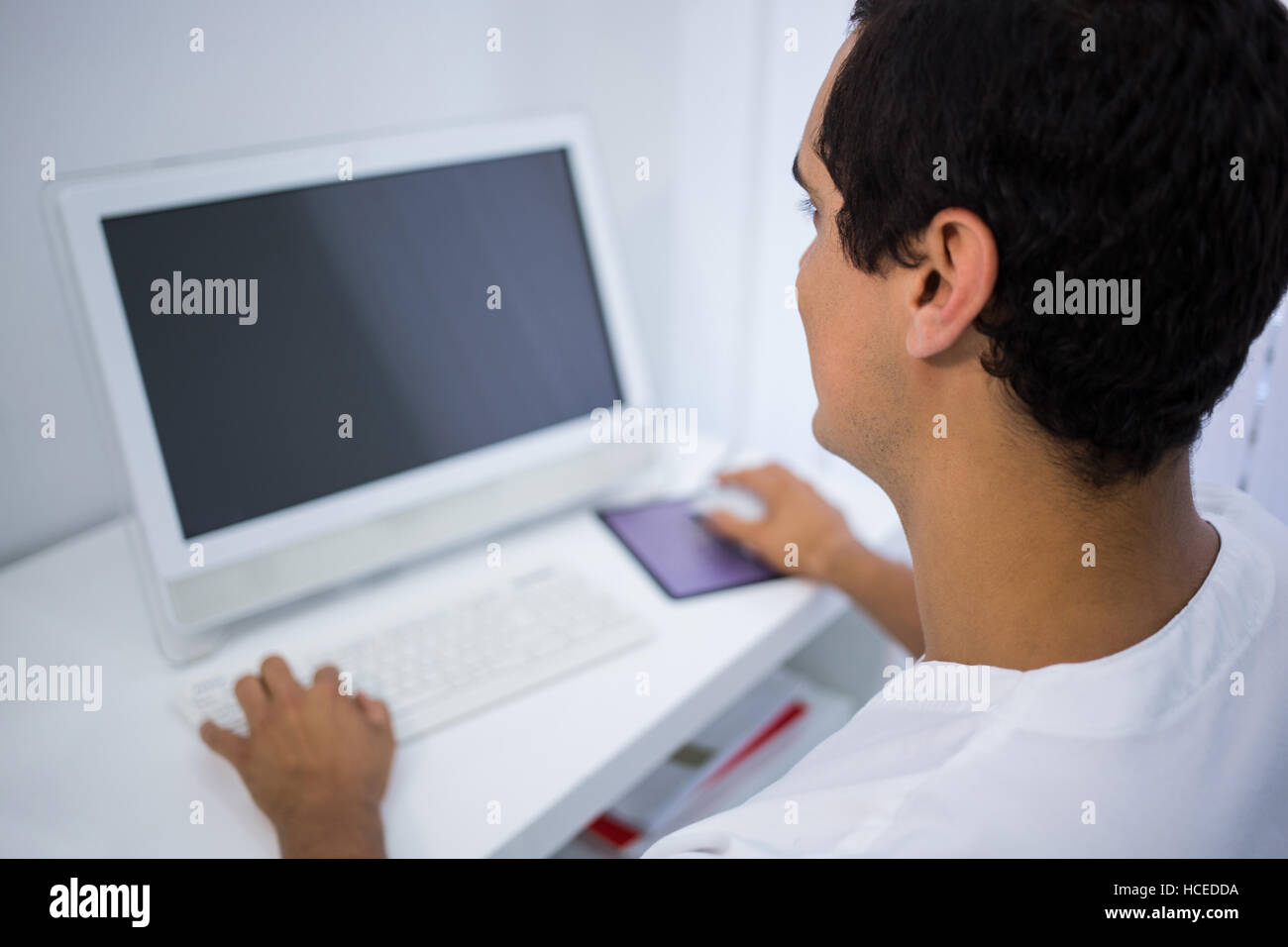 Dentist using computer at clinic Stock Photo