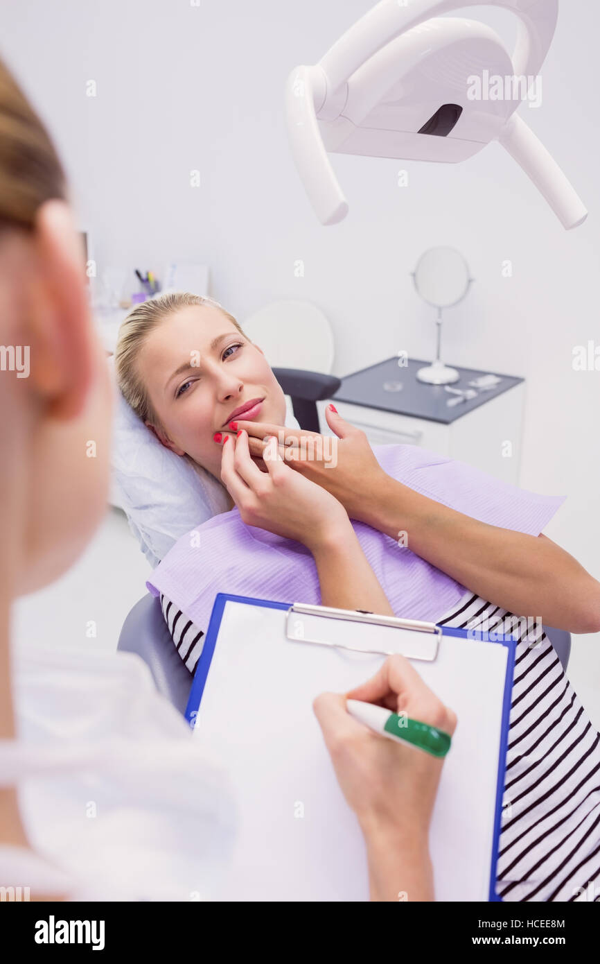 Female patient with toothache in clinic Stock Photo