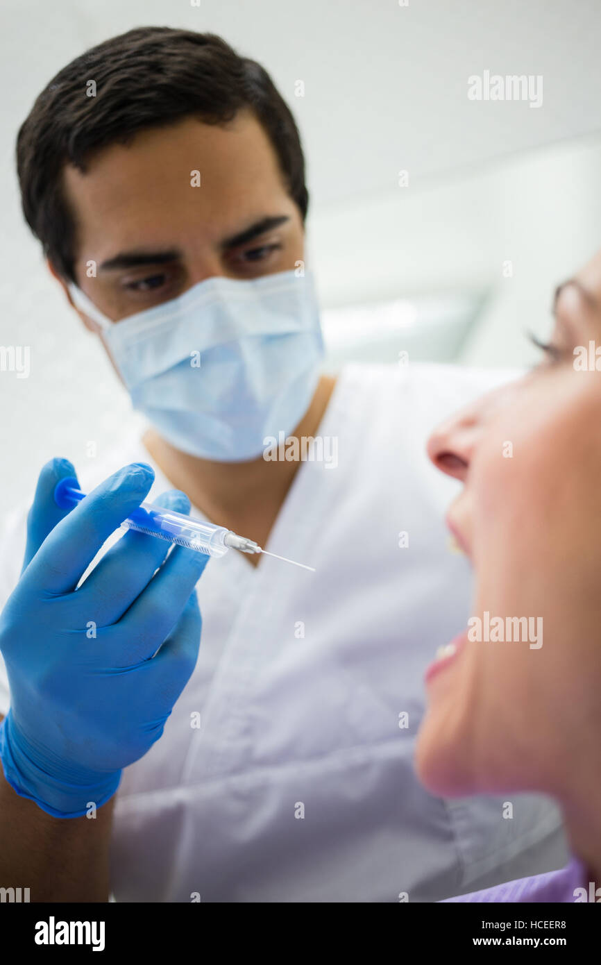 Dentist giving injection to the female patient Stock Photo Alamy