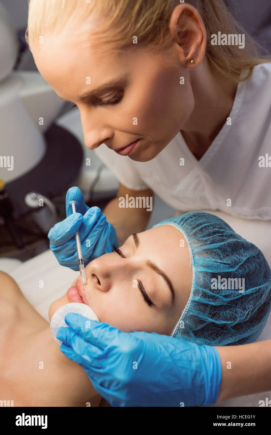 Female patient receiving an injection on her face Stock Photo - Alamy