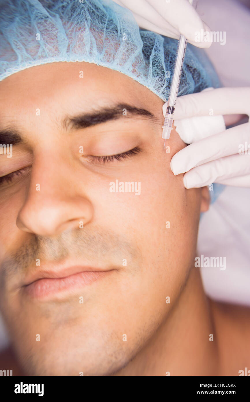 Man receiving botox injection on his face Stock Photo