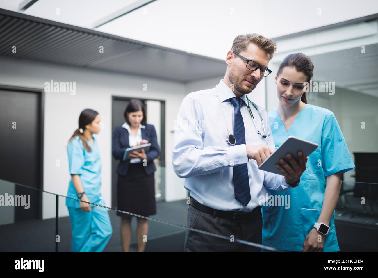 Doctor and nurse discussing over digital tablet Stock Photo