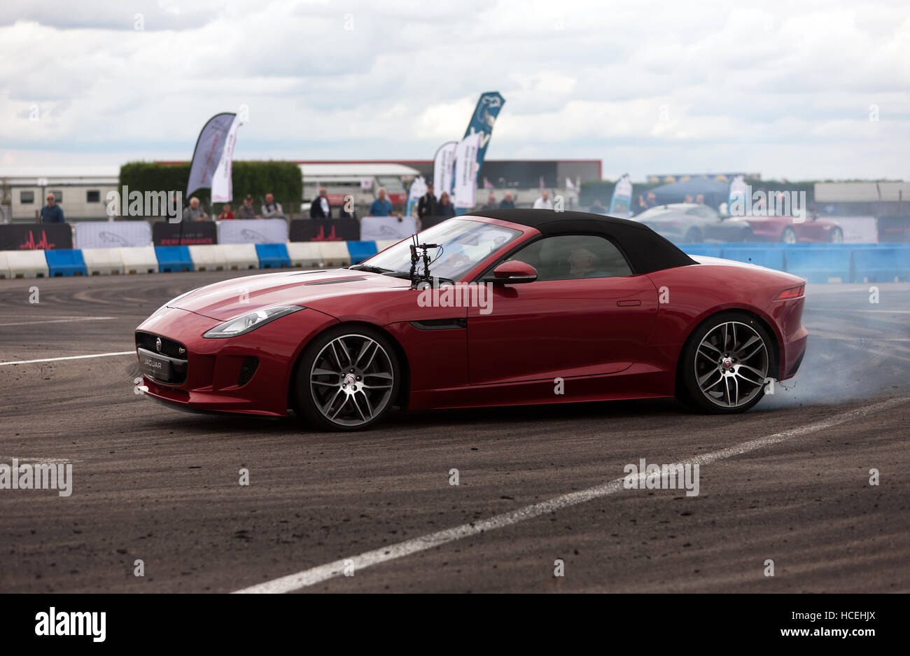 Drifting demonstration  performed in a Jaguar F-Type S  in the adrenaline zone of the Silverstone Classic 2016. Stock Photo