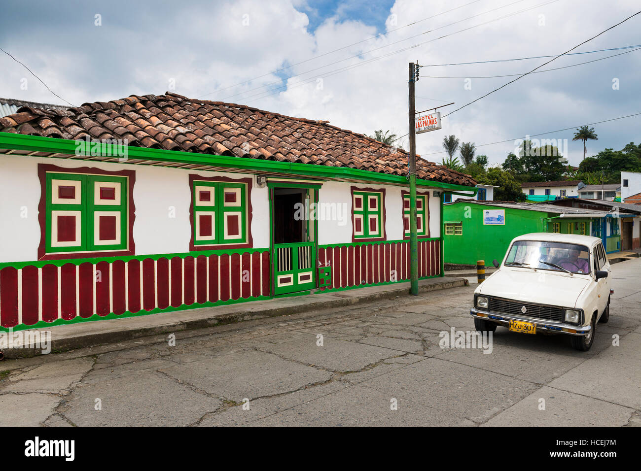 Salento, Colombia - February 10, 2014: An old car in a street of the town of Salento, in Colombia, with an old colorful colonial house; Stock Photo