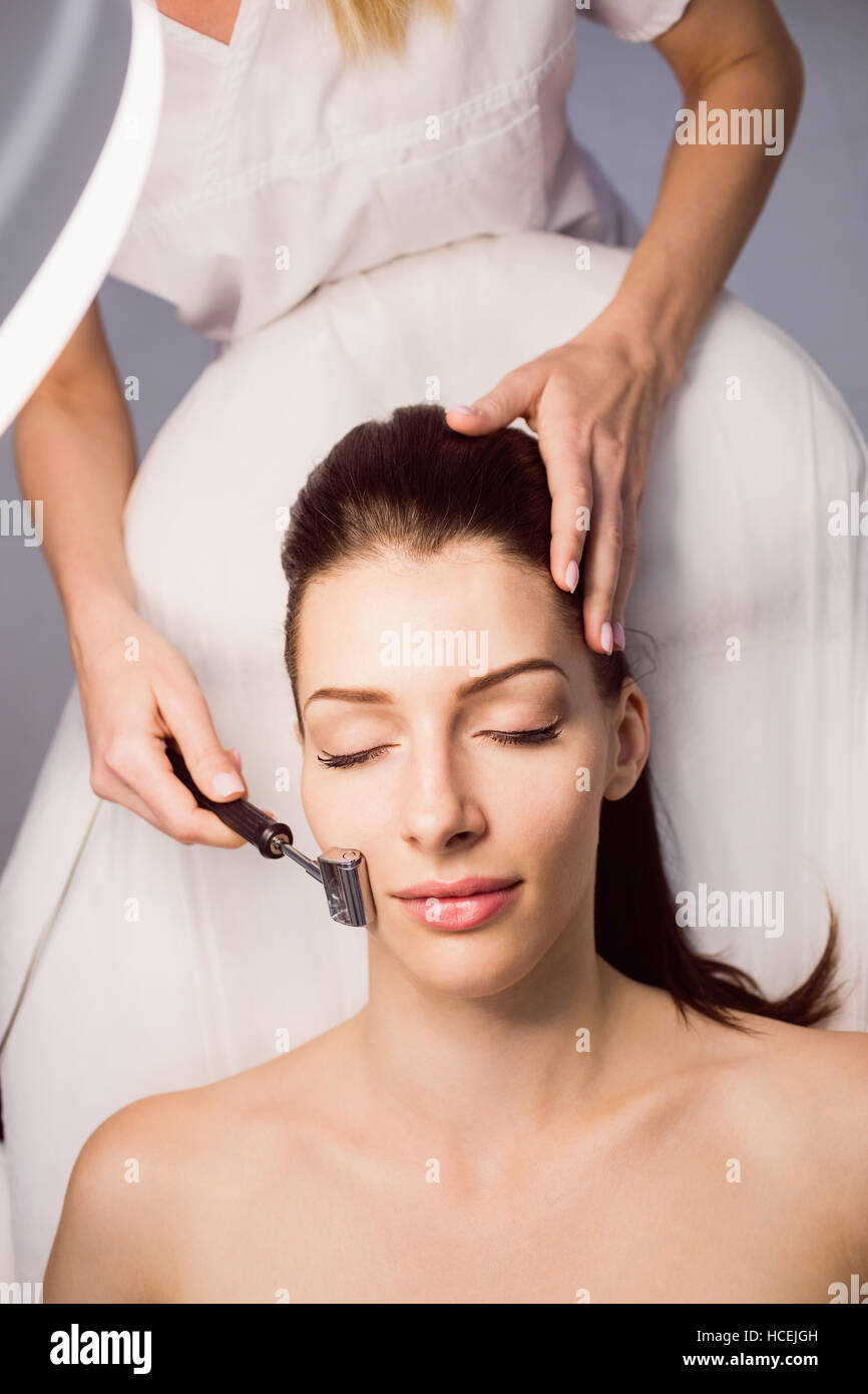 Dermatologist performing laser hair removal on patient Stock Photo Alamy