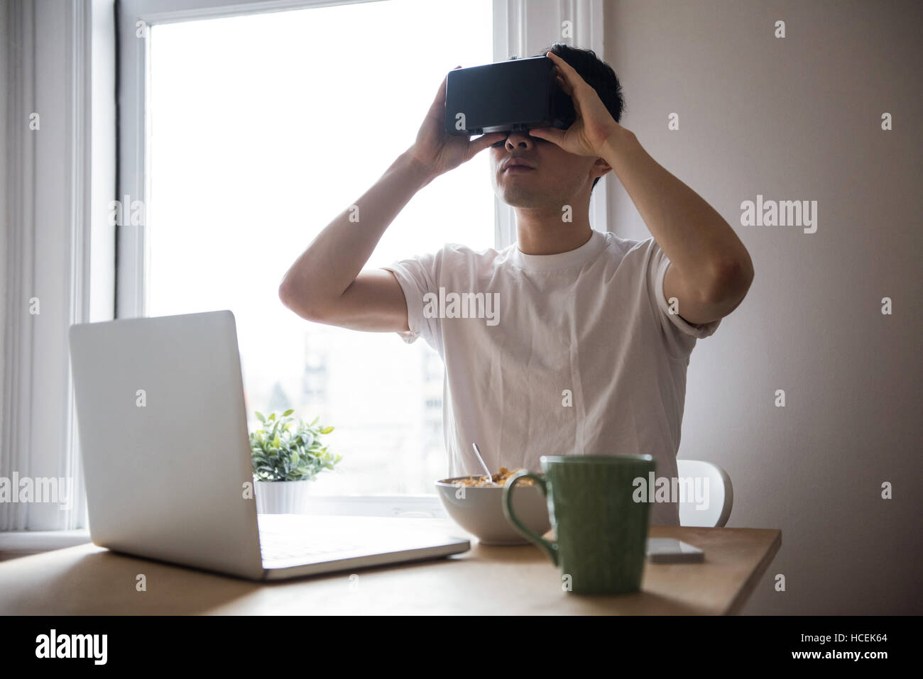 Man using virtual reality headset in living room Stock Photo - Alamy