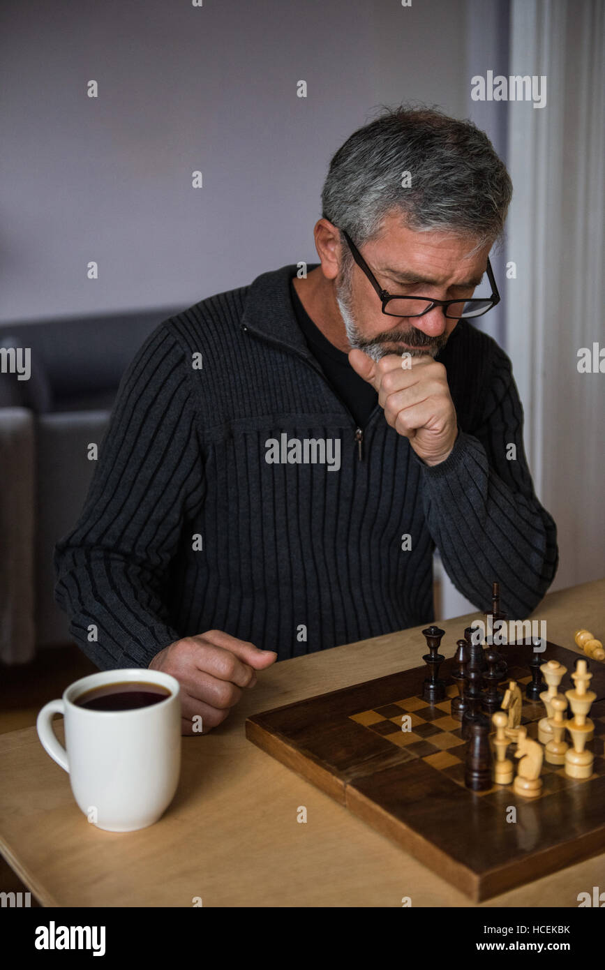 Attentive man playing chess Stock Photo