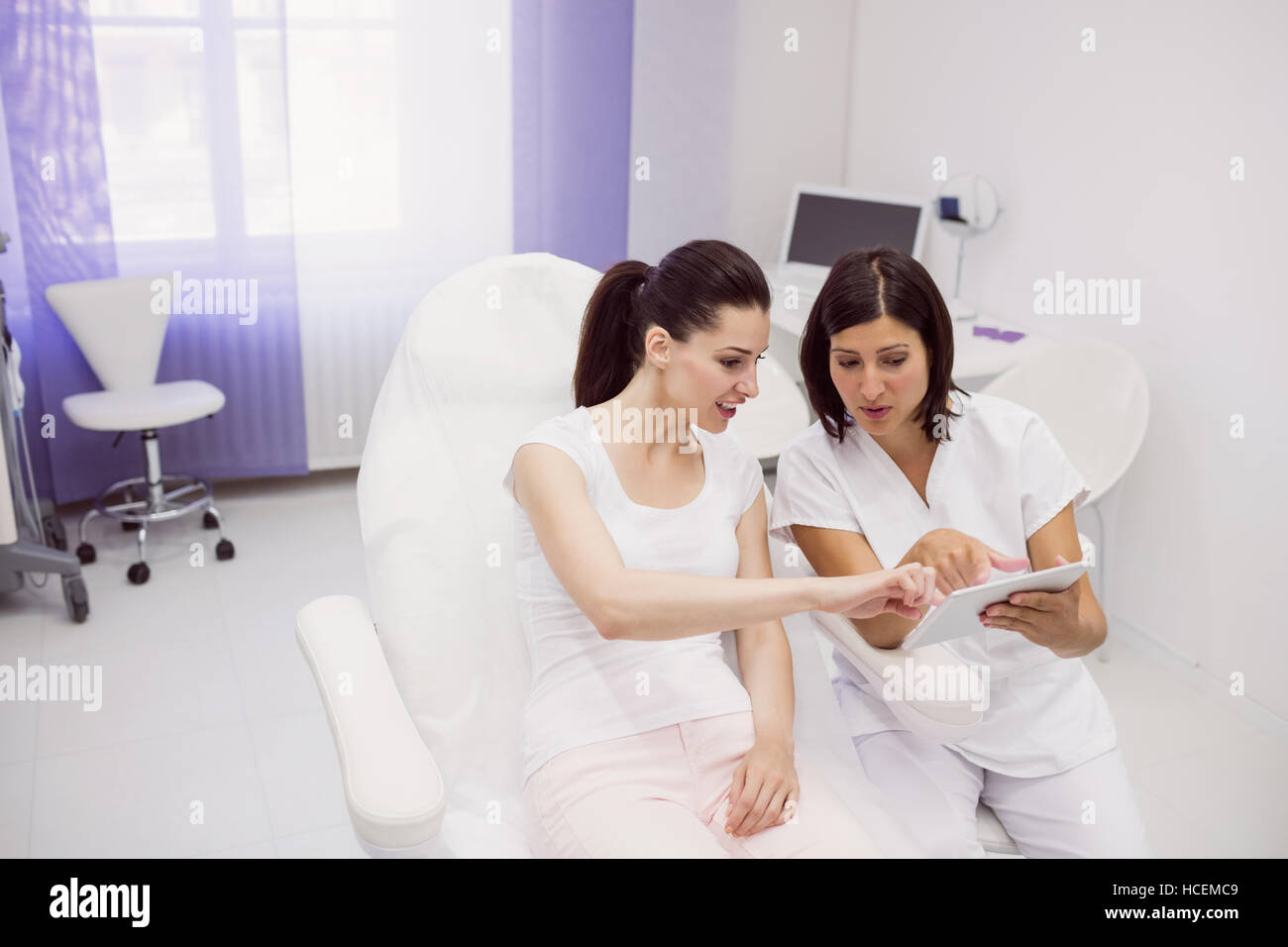 Doctor and female patient discussing on digital tablet Stock Photo
