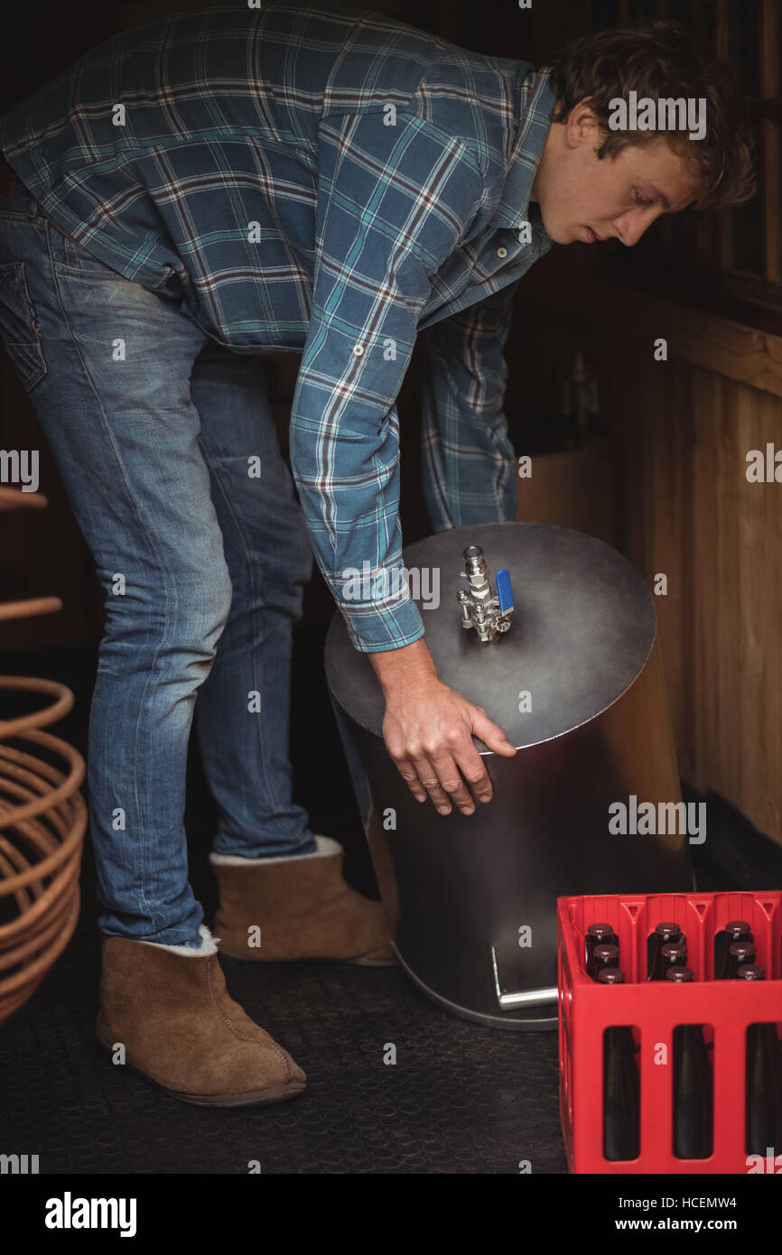 Man lifting wort to make beer Stock Photo Alamy